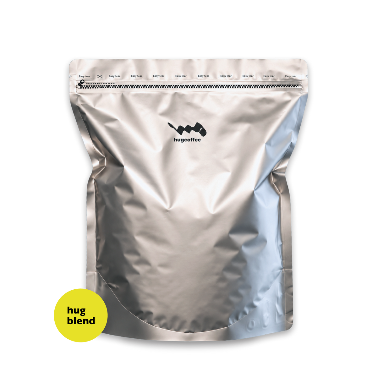hugcoffeeのハグブレンド1kg。銀色のコーヒー豆の袋に黄色の丸いラベル。